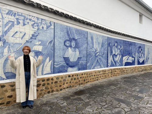 Reina in front of the mural  